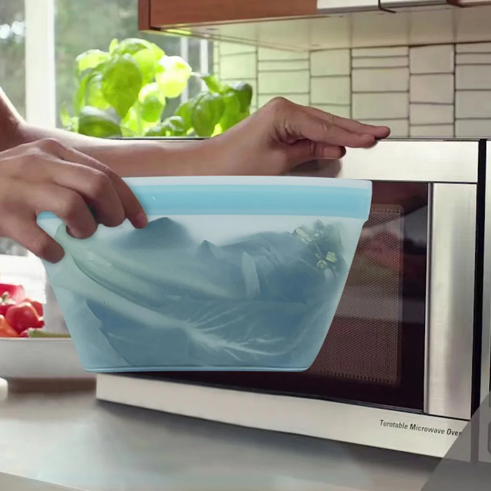 Blue silicone food-storage pouch being placed in a microwave